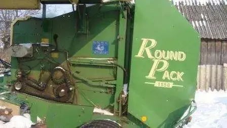 używana prasa zwijająca Krone Round Pack 1550 2000 r podniesiona lewa osłona