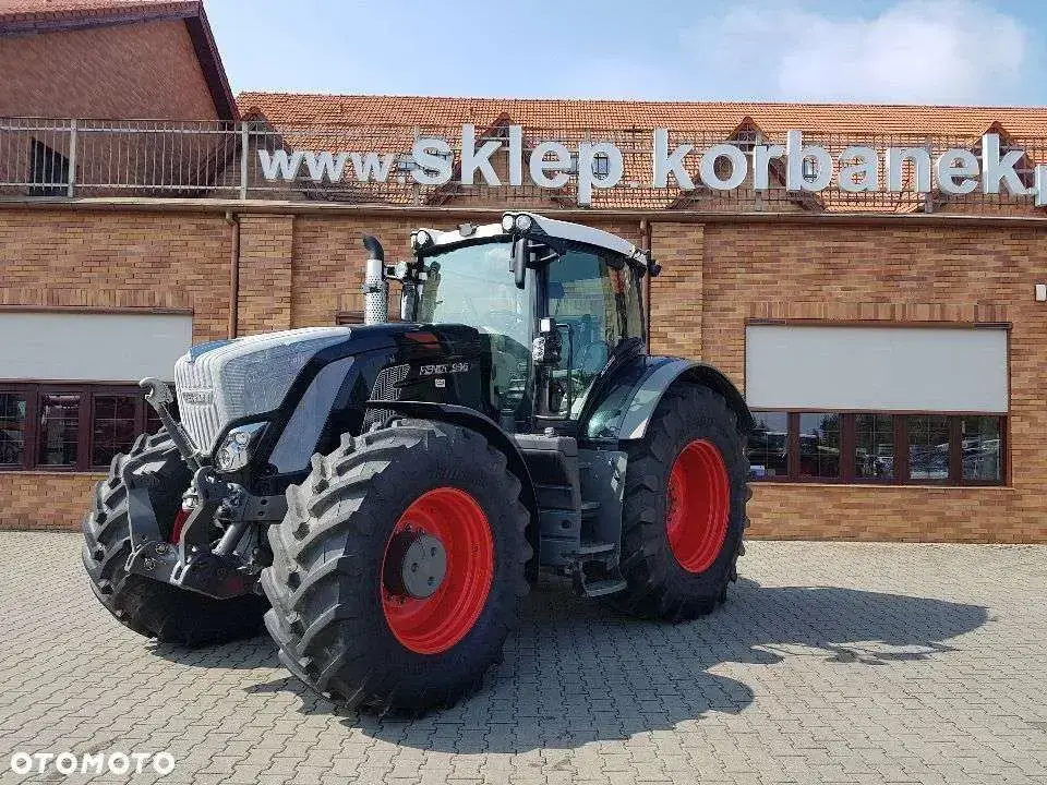Czarny traktor Fendt 936 Vario na tle sklepu częsci widok z lewego boku