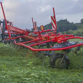 Zawieszany przetrząsacz 8-wirnikowy firmy SIP typ SPIDER 815/8 podczas przetrząsania trawy
