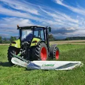 Zielony ciągnik Claas kosi trawę kosiarką dyskową SAMBA 280 firmy Samasz www.korbanek.pl