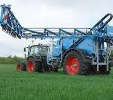 Niebieski opryskiwacz polowy zaczepiany firmy lemken typ Albatros pracujący na polu z ciągnikiem rolniczym Korbanek.pl