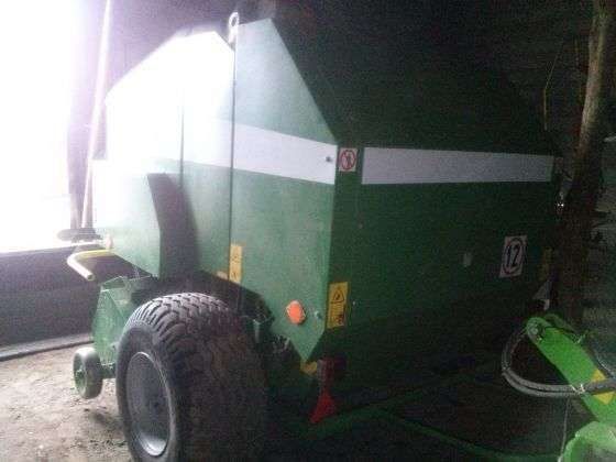 Widok z boku na prasę Sipma zwijająca Farma II używana, stojąca pod wiatą.   
