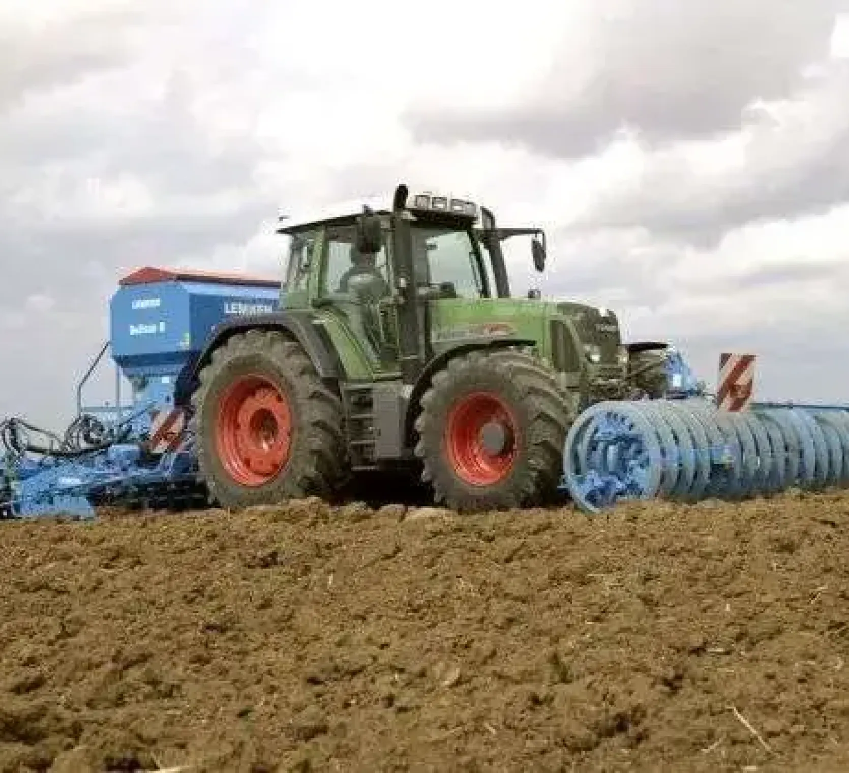 Używany traktor rolniczy Fendt 718 Vario podczas pracy z siewnikiem Lemken oraz wałem uprawowym
