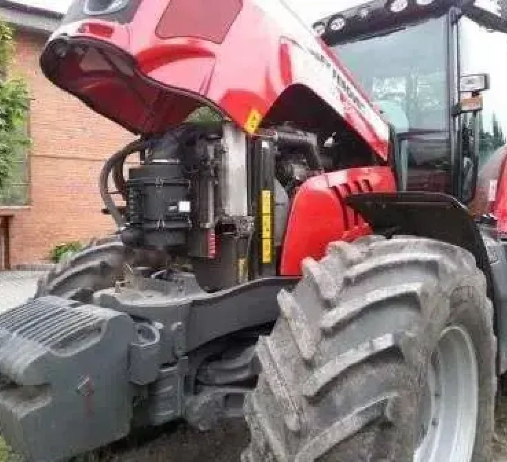 Podniesina maska z widokiem na silnik w ciągniku Massey Ferguson 6495 