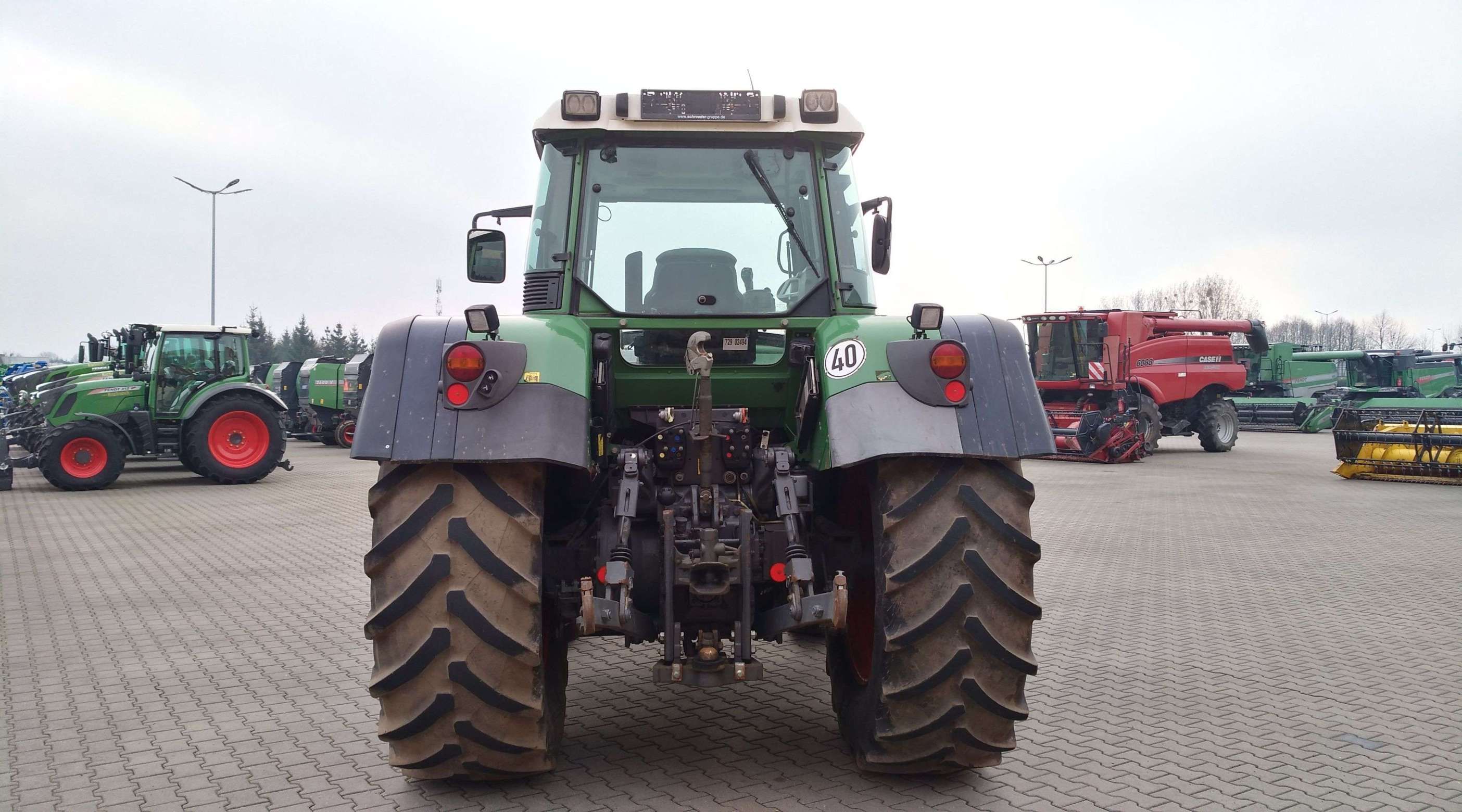 Ciągnik Fendt 818 Vario TMS na tle placu maszyn firmy  Korbanek widok z tyłu