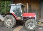 Czerwony używany ciągnik marki Massey Ferguson 3050 widok na bok 