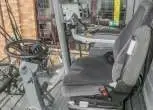 Wnętrze kabiny używanego kombajnu Fendt 6335 widok na kierownice i siedzenie operatora  